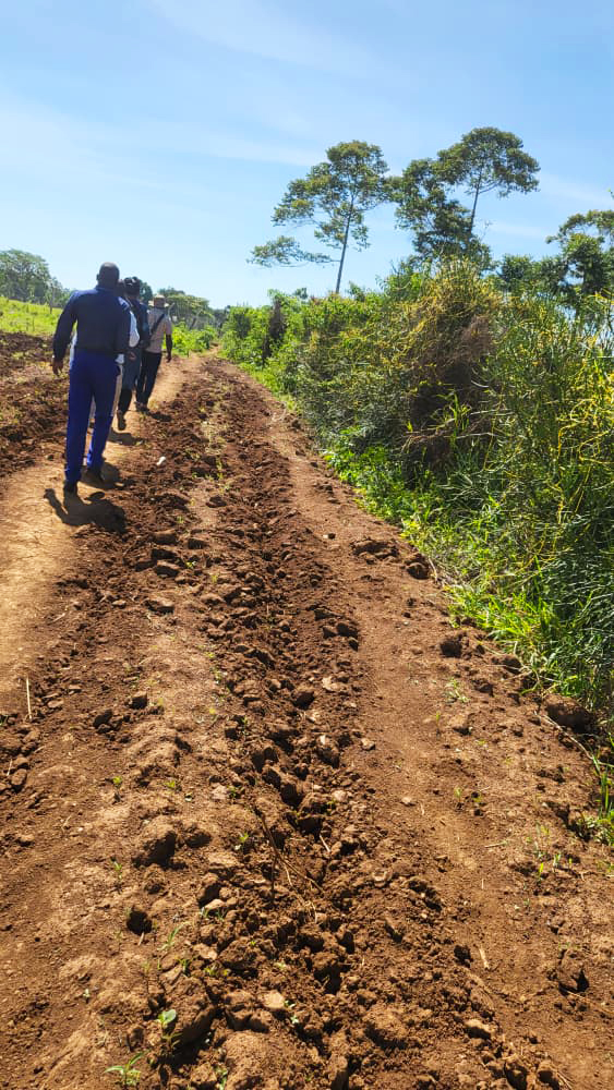The team walks the vocational training grounds at FFYEC Bugiri